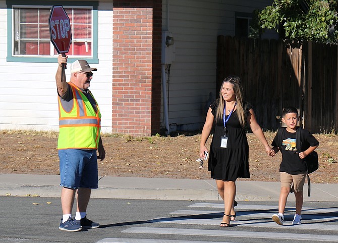 Staff members and crossing guards made sure students and families were given the right of way on the way to school Monday.