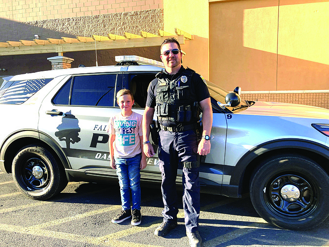 Rylee Owens gets ready for a memorable ride to E.C. Best Elementary with Fallon Police Officer DeWayne Edwards on Aug. 12.