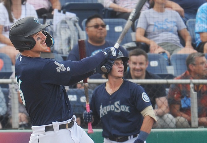 Everett AquaSox’ Calib Cali (left) and Bill Knight watch as the ball sails over the centerfield wall, for Cali’s three-run homer in the third inning of the Sox’s 9-8 win over the Tri-City Dust Devils at Funko Field Sunday, Aug. 18. Cali’s homer in the third was one of three the Sox hit in that inning and four in the game. Michael Arroyo, Freuddy Batista and Jared Sundstrom all belted homers along with Cali. Action was halted for nearly an hour in the fifth inning as heavy rain and hail delayed the game. 
The Sox took five wins of six games against Tri-City in the series. This week, the Sox (23-25 second half, 54-59 overall) take to the road for two weeks: First Vancouver, then Eugene. The team returns to Everett Sept. 2. “Bark in the Park” night is Sept. 4 where fans can bring their dogs.