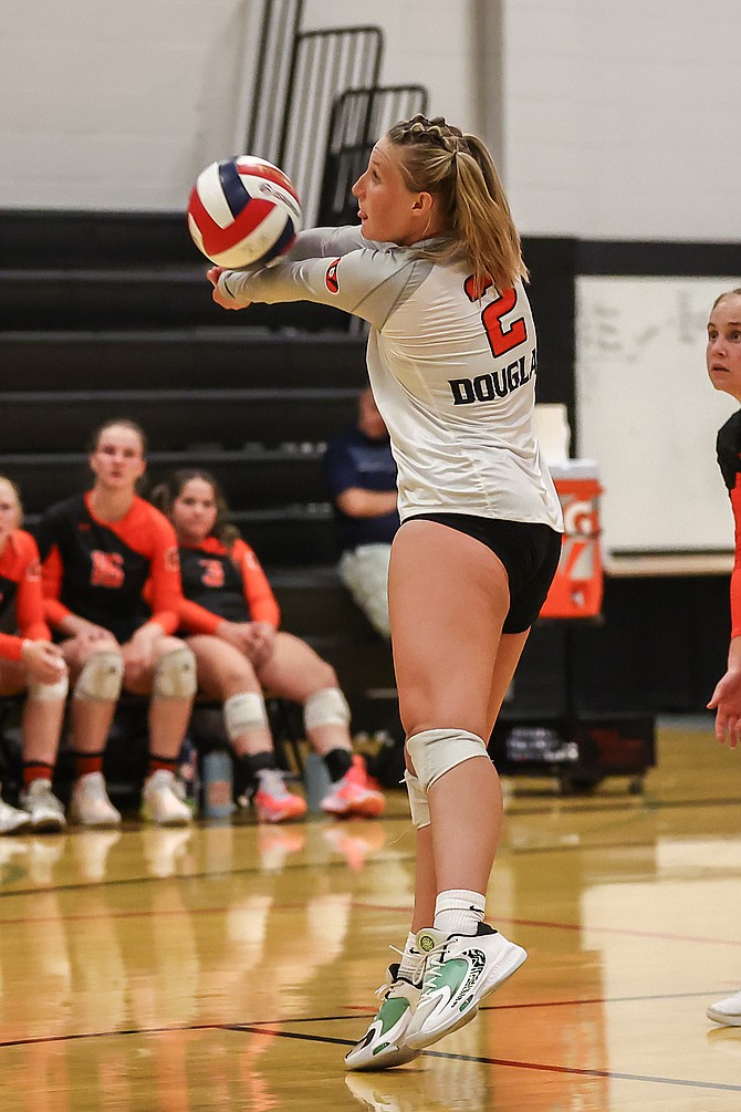 Douglas High's Sumer Williams bumps a ball on return last season against McQueen. Williams and the Tigers will begin their fall season Wednesday at home against Reed.