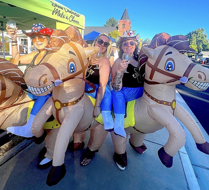 Barb Geibel took this photo of Main Street wine walkers embracing the Champagne at the Bit theme for Thursday's event. Sept. 19 is the last wine walk of the season.