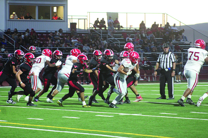 A herd of Mustangs pressures a Wooster ball carrier Az Alvarez.