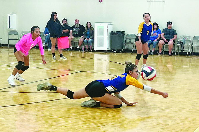 Lowry’s Olivia Espinola dives to the floor for a dig during a match at the Yerington tournament.