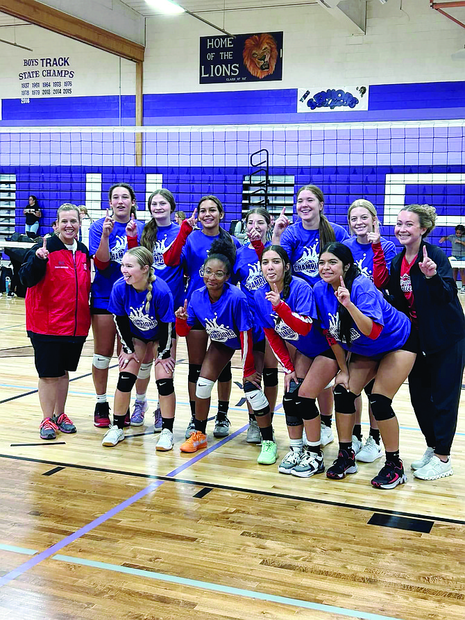 The 2024-25 Pershing County High School volleyball team, Coach Monica Halverson (in red), and JV coach Faith Moreira (in black) celebrate their win at the Yerington tournament.