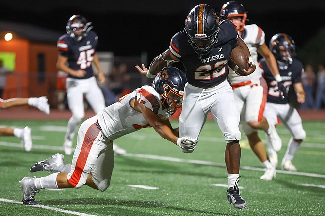 Douglas High’s Mason Almeida (11) makes a shoe-string tackle against Fernley last Friday night. The Tigers’ two-minute offense at the end of the game setup a game-winning field goal to beat the Vaqueros, 16-13.