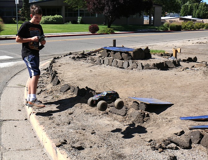 Carson Middle School seventh grader Seth Donnelly uses his RC Traxxas vehicle to jump a set of asphalt barriers Aug. 21, 2024.