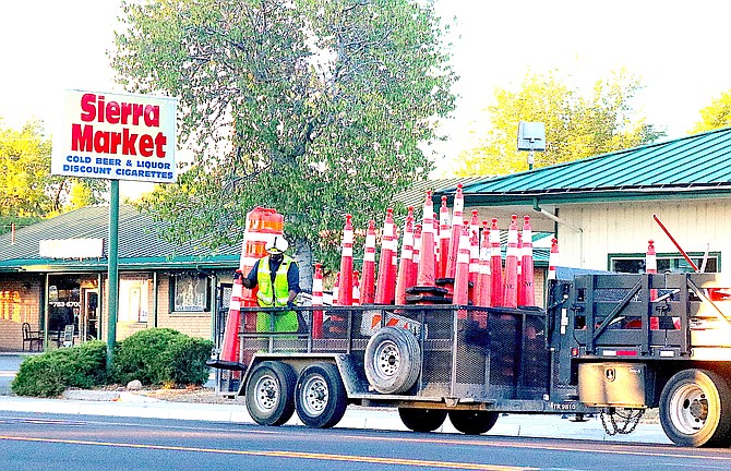 A Sierra Nevada Construction worker picks up cones on Highway 395 through Gardnerville early Wednesday morning.