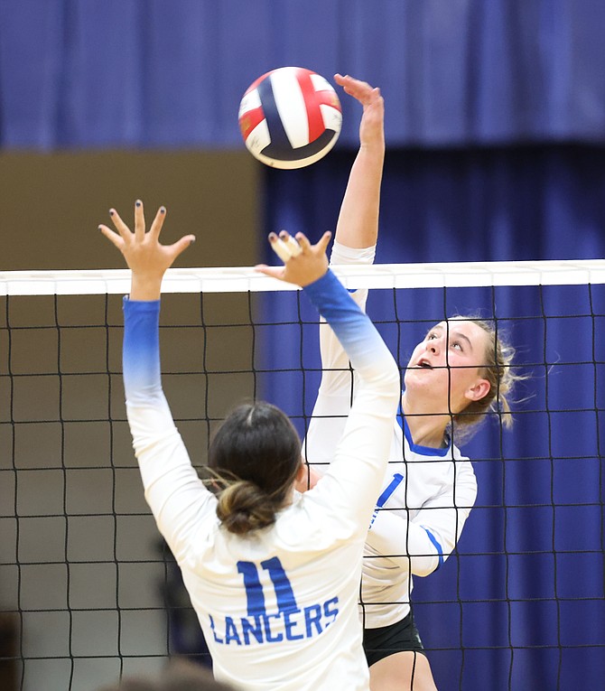 Carson High’s Abby Franco (1) goes up for a kill against McQueen on Thursday. The Senators fell to the Lancers in four sets.