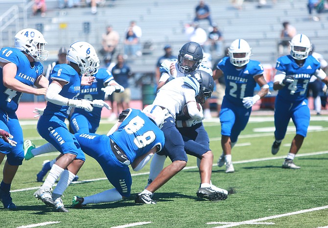 Carson High’s Brayden Welch (88) wraps up a Canyon Springs ball carrier in the 2024 opener, while Nicholas Heald (40), Kekoa Mitchell (6), Christian Rey (21) and Darron Rey (43) all pursue the play. The Senators have a chance to go 3-0 this weekend as they travel to Pocatello, Idaho, to take on Highland High School.