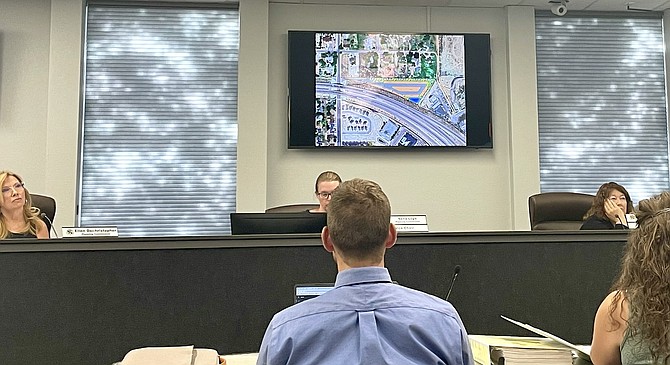 Stephen Pottey of Carson City Public Works, center, along with other staff and commissioners at a Planning Commission hearing Wednesday. On the screen is a rendering of a proposed RV and boat storage area in north Carson.