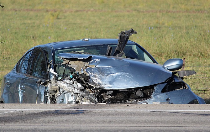 One of two vehicles involved in a head-on collision sits across Highway 395 from the other on Thursday morning.