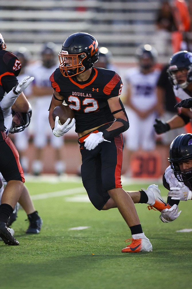 Douglas High running back Zack Jackson (22) looks for a lane Friday evening against Spring Creek. Jackson had a pair of rushing touchdowns in the Tigers' 27-22 win over the Spartans.