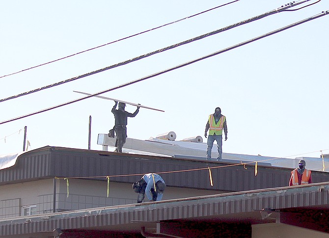 Workers reroof the Gardnerville Fire Station on Thursday morning.