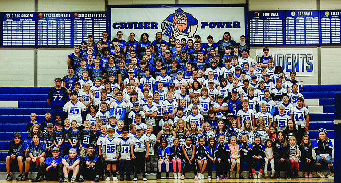 The Eatonville High School football and cheer team's along with the Eatonville Cruiser Youth Football and Cheer programs pose for a group photo following their Big Brother Big Sister event on Aug. 23.