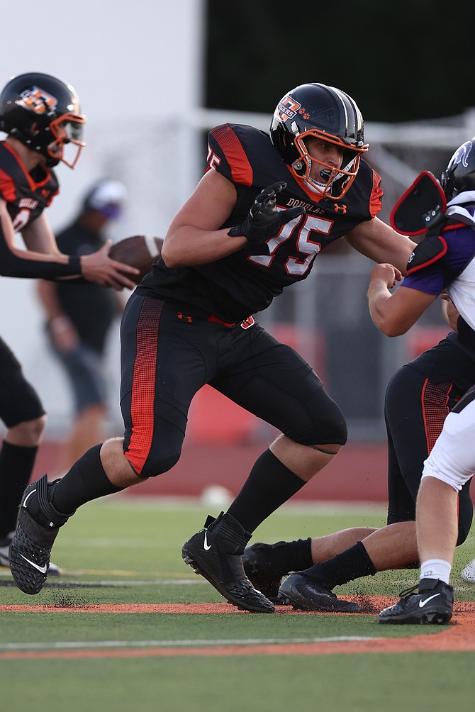 Douglas High’s Drake Ulmer (75) sets up to block a Spring Creek defender Friday night in Minden. Ulmer and the rest of the offensive line allowed the Tigers to rush for 150 yards and three touchdowns in a 27-22 win over the Spartans.