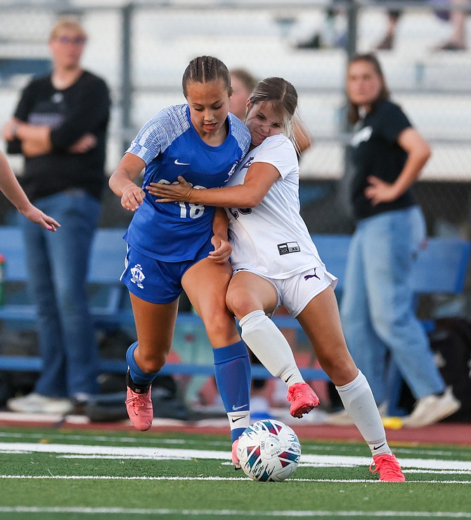 Carson’s Grace Turner battles for possession with a Spanish Springs defender Thursday. Carson girls soccer has four wins this season in its first seven games.