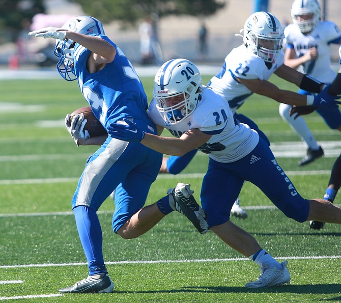 Carson High’s Jake Weninger tracks down a McQueen ball carrier last season. Carson will host McQueen this Friday at 7 p.m.