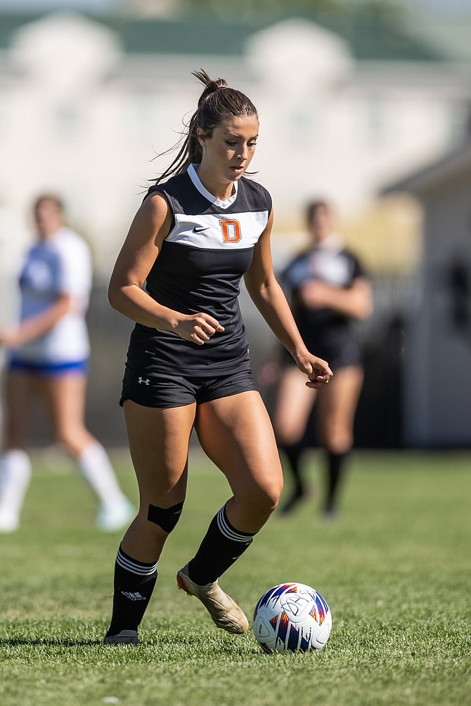 Douglas High senior captain Reese Ballingham dribbles during the Tigers’ 2-1 win over McQueen last week.