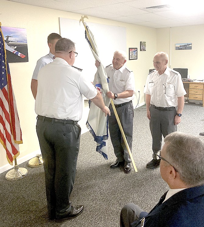 Lt Col. Steven Accinelli receives the flag Nevada Wing Commander Col. Howard as Lt Col. Dale Brown looks on. The Douglas County Composite Squadron hosted a change of command ceremony on Aug. 22. 
Photo Special to The R-C