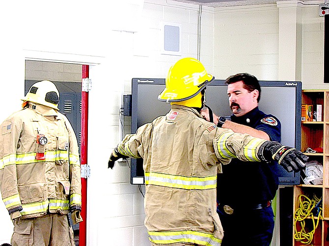 Whittell High School sophomore Wyatt Miller is inspected by Tahoe Douglas Captain Chris Peterson after putting on his turnouts during the high school’s first fire safety class Wednesday.