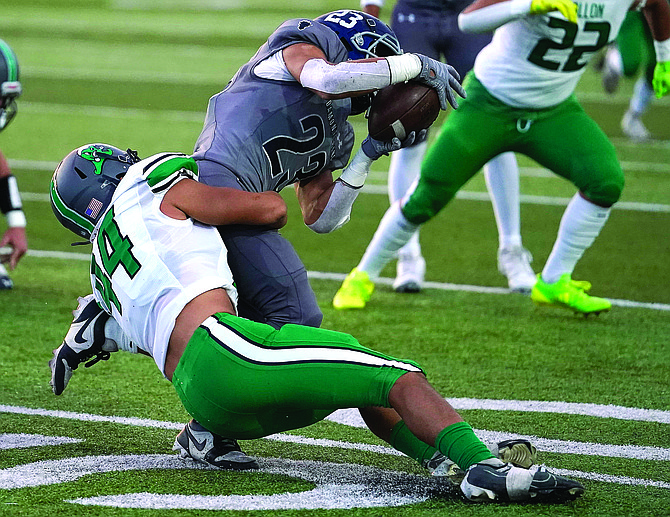 Fallon’s Manny Karaway tackles Damonte Ranch’s Kobe Craig in Friday’s loss to the Mustangs.