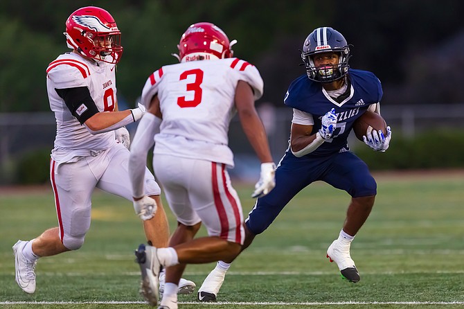 Glacier Peak wide receiver and defensive back, junior Isaiah Owens (No. 7 in blue), darts to get around an onrush of Juanita players during a match between Glacier Peak and Juanita Sept. 6 at Veterans Memorial Stadium in Snohomish. Glacier Peak took the win 33-20. Owens had seven carries and 39 rush yards, according to MaxPreps.com.
Glacier Peak and Snohomish will play a cross-town rivalry game Sept. 13 at Veterans Memorial Stadium.