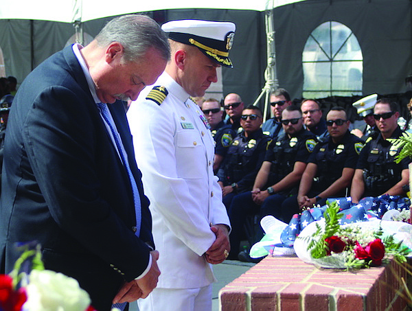 Fallon Mayor Ken Tedford, left, and Capt. Shane Tanner, commander Naval Air Station Fallon, place flowers on the city’s 9/11 wall to remember those killed 23 years ago.