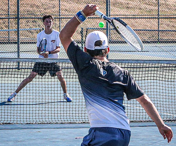 Glacier Peak left hander, Nathen Olson powers a shot over the net to Monroe Senior, Jacob Shafer in the number one court  Singles match on Wednesday, September 4, 2024 in Monroe.  Shafer lost in straight sets and Monroe dropped the match 2 - 5 under a blistering sun.