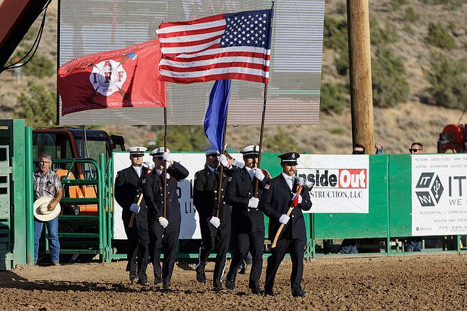 A color guard from the East Fork chapter of the International Association of Firefighters brings out the flags at the Douglas County Rodeo on Friday. Today marks the 23rd anniversary of the attacks that killed 343 firefighters and 72 law enforcement officers, among the 2,996 lost.