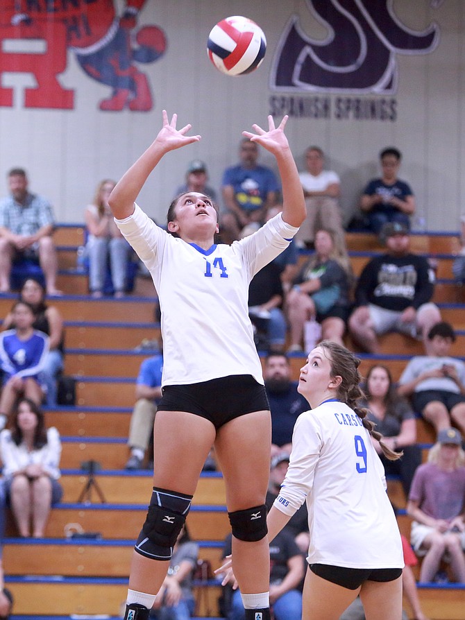 Carson High’s Julie Salanoa (14) jumps into the air while setting the ball against Damonte Ranch last week while Hannah Gerow (9) looks on. Salanoa had 20 assists for the Senators in a 3-0 win over Reed Thursday.