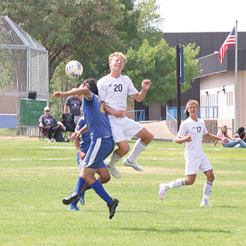 Lowry’s Victor Barajas goes up to head the ball in Saturday’s match with Spring Creek.