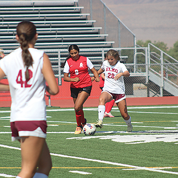 Riley Harvey races Elko to the ball.