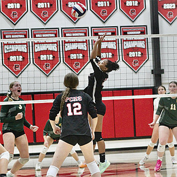 Pershing County’s Kenya Vaughan sets the ball for a teammate.