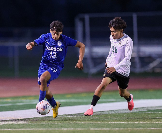 Carson high defender Angel Vega (13) runs past an Incline player earlier this season. Vega and the Senators fell to Damonte Ranch, 1-0, Saturday afternoon at home.