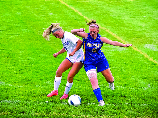 Eatonville's Haley Courson fights for possession with Rochester's Harley Frahman in the Cruisers opening match of the season. Courson would start off the season recording a hat trick in the match.