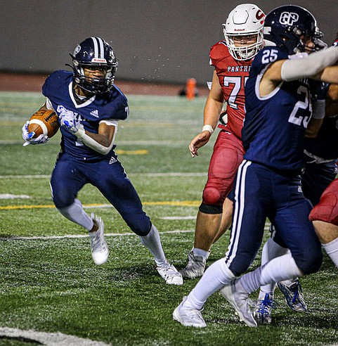 Glacier Peak junior Isaiah Owens jukes around the end on his way to 209 yards rushing and three touchdowns during the Glacier Peak Grizzlies’ 
27 - 0 win over the Snohomish Panthers under a threatening sky on Friday, Sept. 13 in Snohomish. 
The first half was a penalty-filled struggle until the final 10 seconds when the Grizzlies struck with a 
long run to score.  The highlight of Snohomish’s evening was when  the Snohomish defense held a fine goal line stand following  a fumbled punt. Panthers QB David Hammer threw 89 yards, Mason Surdi caught for 74 and Brody Strandt ran for 98.
Glacier Peak has continued its streak of winning the annual cross-town rivalry game for the battle for the Dick Armstrong Cup, named for the tough Snohomish High football coach.