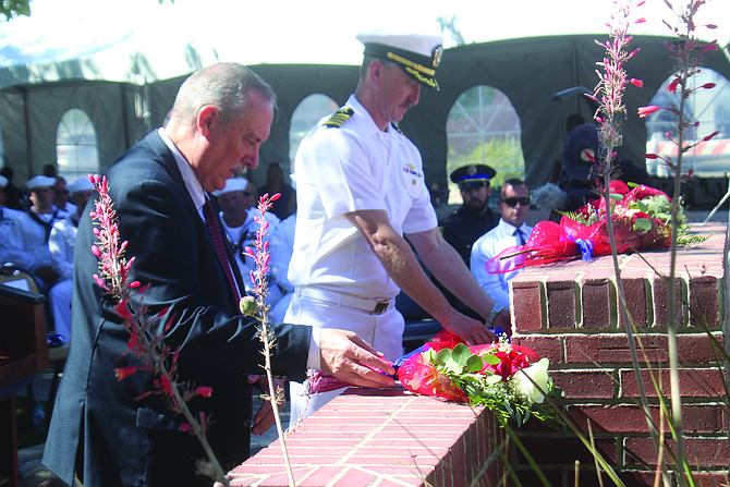 Fallon Mayor Ken Tedford and Navy Cpt. Andrew Mariner lay flowers at the city’s 9/11 memorial.