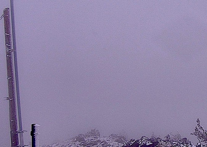 A little snow shows up on the Snow Valley Peak Alert Wildfire camera on Tuesday morning.