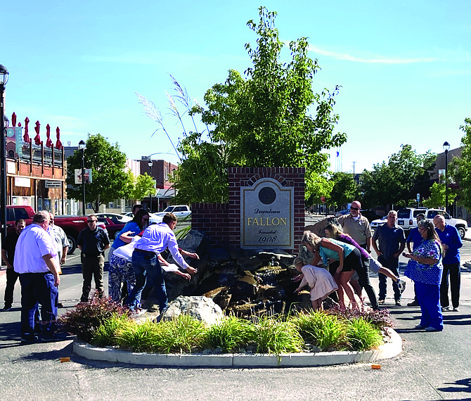 City, county, and school district representatives dye the Maine Street fountain purple on Sept. 9 in a joint proclamation for “Suicide Prevention Awareness Month.”