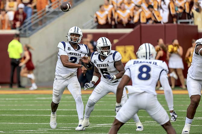 Nevada quarterback Brendon Lewis (2) passes to receiver Cortez Braham (8), with Patrick Garwo (5) providing blocking last week against Minnesota.