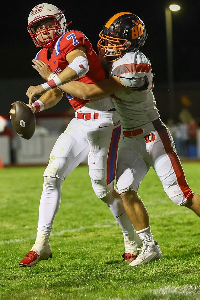 Douglas High's Braden Lenz (80) records a sack against Reno's quarterback Friday night, during the Tigers' 20-13 win over the Huskies to open Class 5A North Div. II league play.