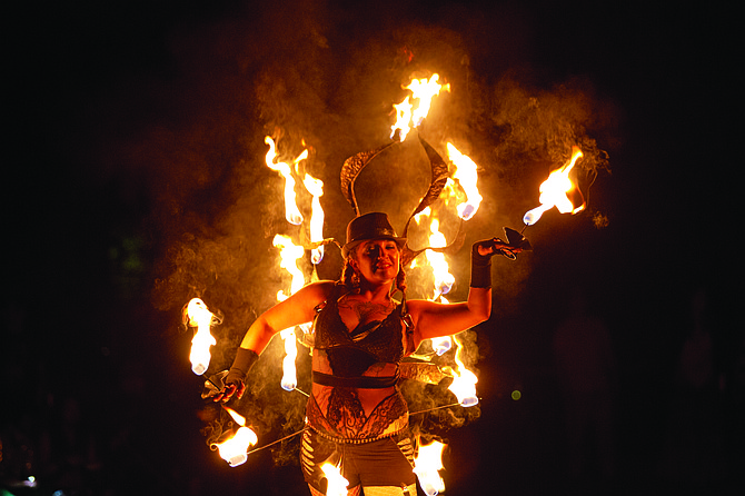 Reporter and editorial graphic designer Kyler Klix place first in the portrait category for his photo of a fire dancer.