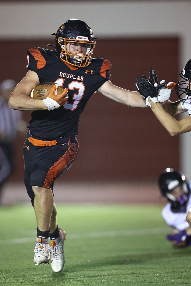 Douglas High’s Brenton Weston stiff-arms an opponent earlier this season. Weston has 471 yards receiving and seven touchdowns for the Tigers this fall, along with 35 tackles on defense.