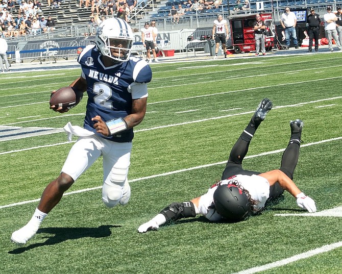 Nevada quarterback Brendon Lewis avoids a tackle in the first half of Nevada’s home game on Saturday against Eastern Washington.