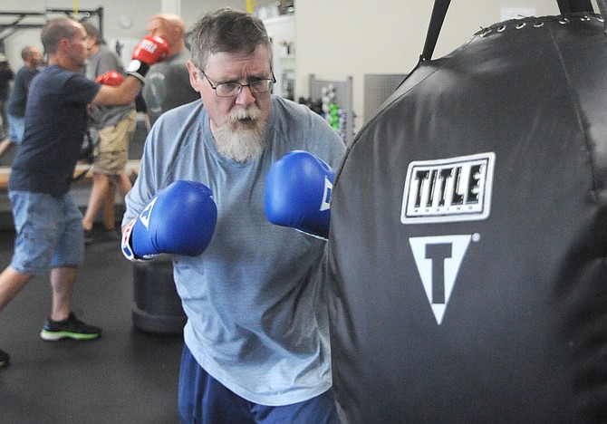 Dana Wlazlak does a little sparring with the boxing bag during a work-out session Thursday, Sept. 19 at the Parkinson’s Wellness Place in Snohomish.