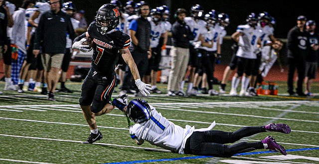 The Monroe Bearcats blitzed the Shorewood Stormrays 49 - 7 in the Bearcats’ season home opener on a football perfect Friday evening Sept. 20. Above, Bearcat #7, 5’8”, 180 pound senior Mason Davis breaks a tackle in first quarter play. The Bearcats took the opening kickoff into the end zone and then scored about every time they had the ball. The half time tally was 42 - 0 with the Bearcats having at least one touchdown called back. Davis and teammate running back, junior BK Kingsley, both rushed to make touchdowns for Monroe. Monroe posted 407 yards rushing and 78 in the air and displayed a stingy defense. Despite the few passing yards, wide receiver senior Aaron Clifton caught for 18 points toward the Bearcats’ tally.