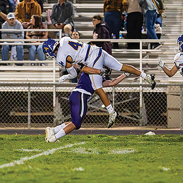 Lowry's Anthony Monroy fights his way for more yardage after a reception.