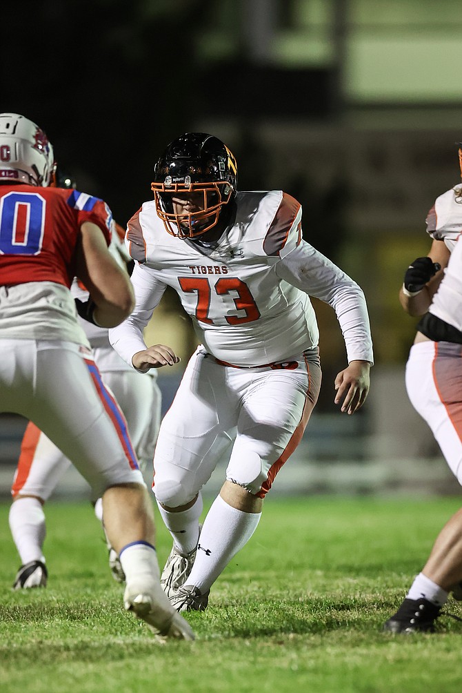 Douglas High lineman Curtis Haliwell (73) kicks out to block during Douglas’ 20-13 win over Reno on Friday night.