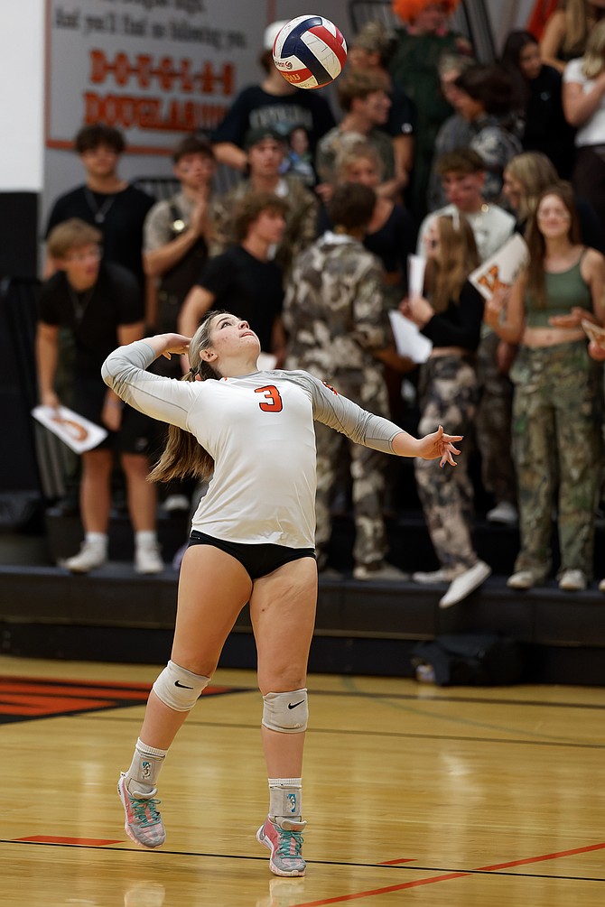 Douglas’ Emersyn Worthington lines up a serve Thursday against McQueen. The Tigers fell in four sets to the Lancers.