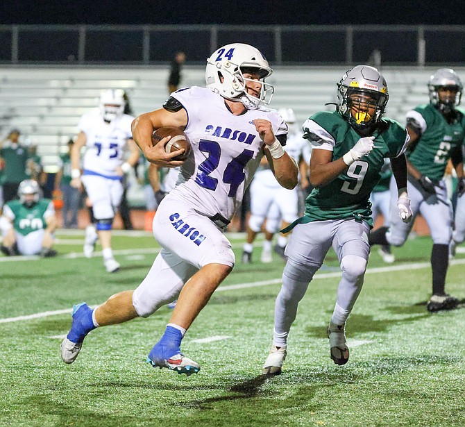 Carson High’s JT Heaton (24) gets around the edge on a rushing touchdown this past Friday night against Hug. Heaton ran for 48 yards on three carries and three tackles on defense in a 37-0 win over the Hawks.